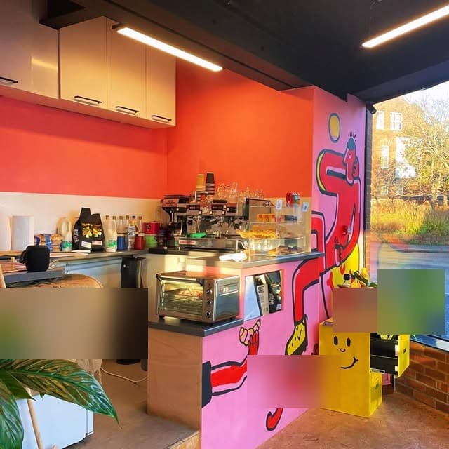Foreshore's interior — hot-pink counter wall with the red dancing mural and a smiley box